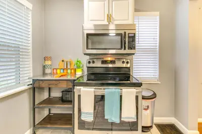 a kitchen with a stove and a microwave at Walk to Main Street Charming Bellevue Home in Bellevue