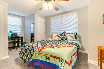 a bedroom with a bed and a ceiling fan at Walk to Main Street Charming Bellevue Home in Bellevue