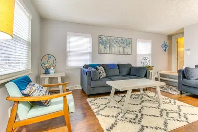 a living room with a couch and a table at Walk to Main Street Charming Bellevue Home in Bellevue