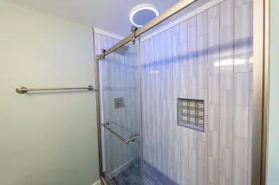a shower with a glass door in a bathroom at Oberlin Getaway in Oberlin