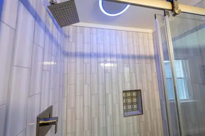 a bathroom with a shower with a window on the wall at Oberlin Getaway in Oberlin