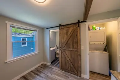 a bathroom with a sliding barn door in a house at Oberlin Getaway in Oberlin