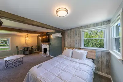 a bedroom with a large bed and a fireplace at Oberlin Getaway in Oberlin