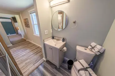 a bathroom with a sink and a toilet and a mirror at Oberlin Getaway in Oberlin