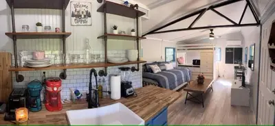 a kitchen and living room with a couch in a room at Covered Bridge Hideaway, swimming hole hot tub in Stanton