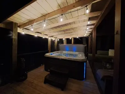 a room with a tub in a room with lights at Hocking Hills Cabin, Hot Tub, Private Pond in McArthur