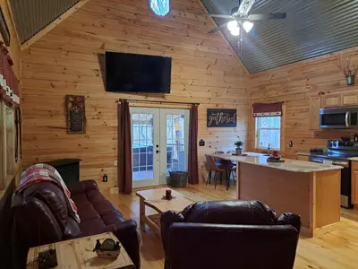 a living room with a couch and a table at Hocking Hills Cabin, Hot Tub, Private Pond in McArthur