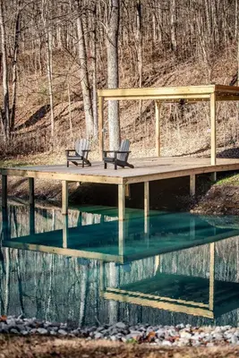 two chairs sitting on a dock over a body of water at Hocking Hills Cabin, Hot Tub, Private Pond in McArthur