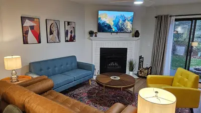 a living room with a blue couch and a fireplace at North Columbus Townhouse - Central, Updated, Fireplace in Columbus
