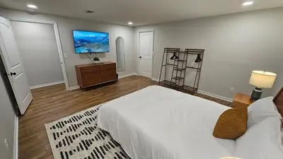 a bedroom with a bed and a tv on the wall at North Columbus Townhouse - Central, Updated, Fireplace in Columbus