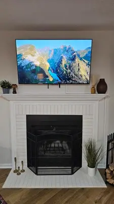 a fireplace with a flat screen tv above it at North Columbus Townhouse - Central, Updated, Fireplace in Columbus