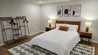 a bedroom with a bed with two night stands and two lamps at North Columbus Townhouse - Central, Updated, Fireplace in Columbus