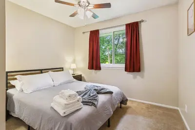 a bedroom with a bed with a ceiling fan and a window at CVNP Winter Getaway - 5 mins to Boston Mills Ski in Northfield