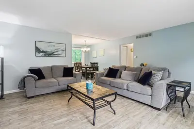 a living room with two couches and a table at CVNP Winter Getaway - 5 mins to Boston Mills Ski in Northfield