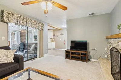 a living room with a couch and a television at CVNP Winter Getaway - 5 mins to Boston Mills Ski in Northfield