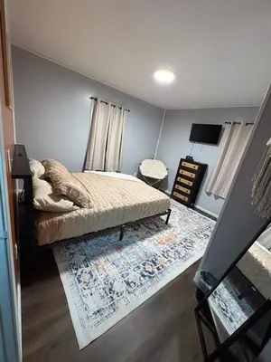 a small bedroom with a bed and a rug at HiddenJewel in Springfield