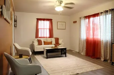a living room with a couch and a table at HiddenJewel in Springfield