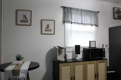 a room with a table with a microwave and a window at HiddenJewel in Springfield
