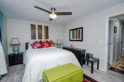 a bedroom with a bed and a ceiling fan at Lovely Eclectic Duplex - Peaceful Neighborhood in Trotwood