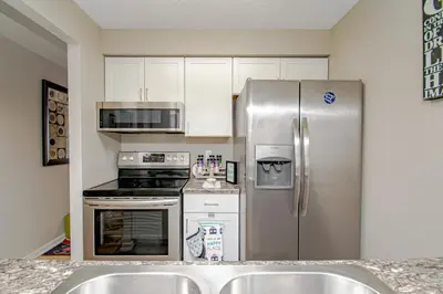 a kitchen with a stainless steel refrigerator and appliances at Lovely Eclectic Duplex - Peaceful Neighborhood in Trotwood
