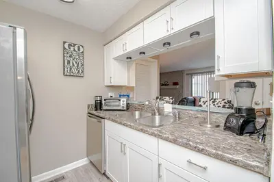 a kitchen with white cabinets and a counter top at Lovely Eclectic Duplex - Peaceful Neighborhood in Trotwood