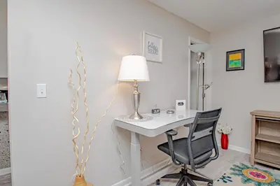 a desk with a lamp and a chair in a room at Lovely Eclectic Duplex - Peaceful Neighborhood in Trotwood