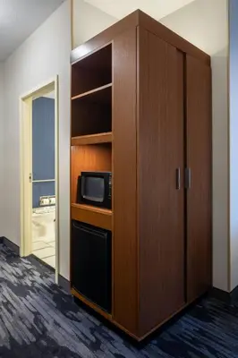 a cabinet with a microwave in a room at Fairfield Inn & Suites by Marriott Columbus Dublin in Dublin
