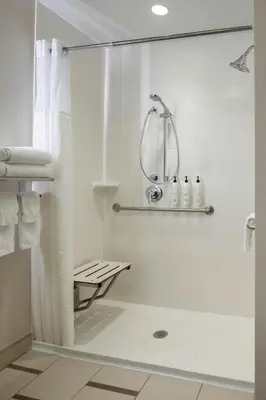 a white bathroom with a shower and a sink at Fairfield Inn & Suites by Marriott Columbus Dublin in Dublin