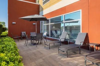 a patio with tables and chairs and an umbrella at Fairfield Inn & Suites by Marriott Columbus Dublin in Dublin