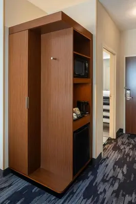a room with a cabinet with a microwave and a television at Fairfield Inn & Suites by Marriott Columbus Dublin in Dublin