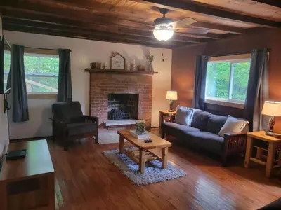 a living room with a couch and a fireplace at Mountainside Cabin, Secluded, Hot Tub, Lake Accessible in Rockbridge