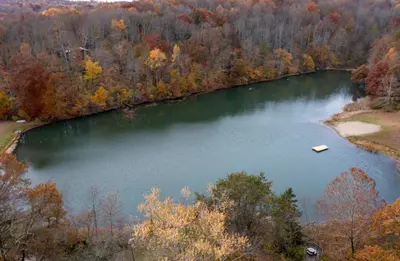 an aerial view of a lake with a boat in it at Mountainside Cabin, Secluded, Hot Tub, Lake Accessible in Rockbridge