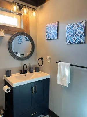 a bathroom with a sink and a mirror at Nature Mystique Retreat 3 Bedroom Moroccan Cabin in Creola