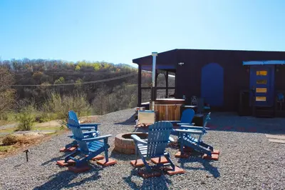 a group of chairs and a table in a yard at Nature Mystique Retreat 3 Bedroom Moroccan Cabin in Creola