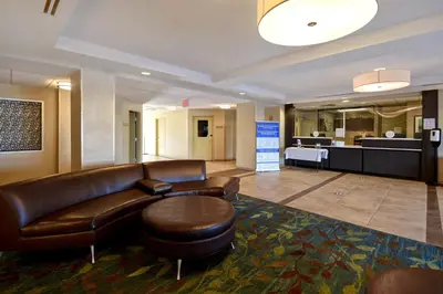 a lobby with a leather couch and a waiting room at Candlewood Suites St Clairsville Wheeling Area by IHG in Saint Clairsville