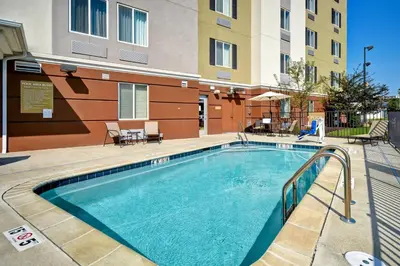 a swimming pool in front of a apartment building at Candlewood Suites St Clairsville Wheeling Area by IHG in Saint Clairsville