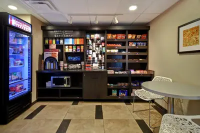 a coffee shop with a counter and a table at Candlewood Suites St Clairsville Wheeling Area by IHG in Saint Clairsville