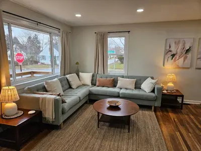 a living room with a couch and a table at Clintonville Charmer - Central, Arcade, Selfie Wall in Columbus