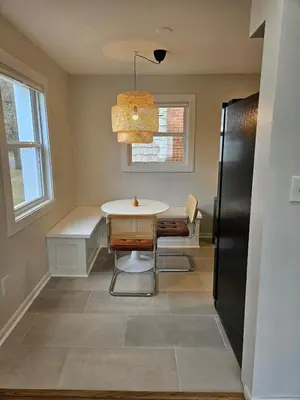 a dining room with a table and chairs and a window at Clintonville Charmer - Central, Arcade, Selfie Wall in Columbus
