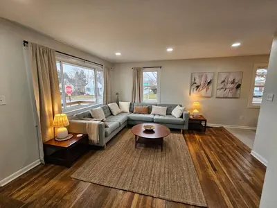 a living room with a couch and a table at Clintonville Charmer - Central, Arcade, Selfie Wall in Columbus