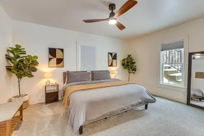 a bedroom with a bed and a ceiling fan at 3 Mi to Downtown Youngstown Updated Apartment in Youngstown