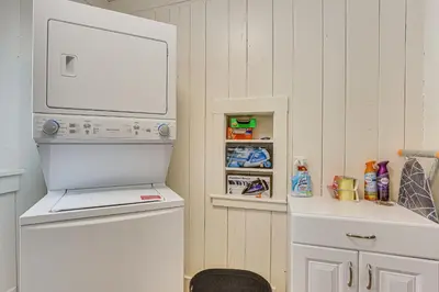a kitchen with a refrigerator and a shelf with food at 3 Mi to Downtown Youngstown Updated Apartment in Youngstown