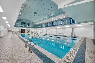 a large swimming pool in a large building at Your Downtown Oasis, Pool Gym in Building Steps from Dining and Top Sights in Cleveland