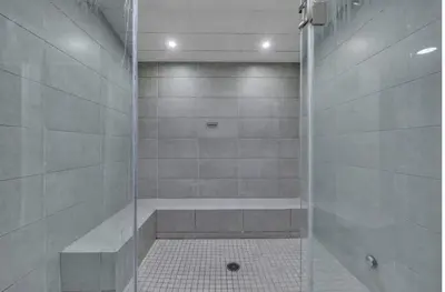 a shower with a glass door in a bathroom at Your Downtown Oasis, Pool Gym in Building Steps from Dining and Top Sights in Cleveland