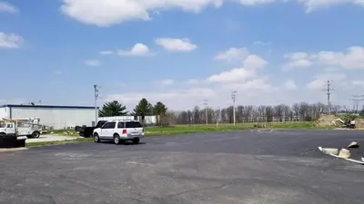 a white car parked in a parking lot at Greenfield Inn in Greenfield