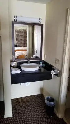 a bathroom with a sink and a mirror at Greenfield Inn in Greenfield