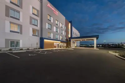 an empty parking lot in front of a hotel at Hampton Inn Mt. Vernon Oh in Academia