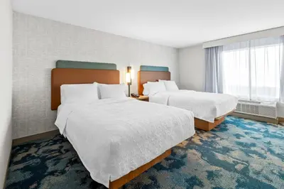 a hotel room with two beds and a window at Hampton Inn Mt. Vernon Oh in Academia