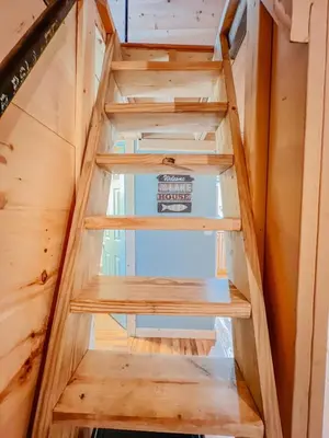a staircase in a tiny house at Lake Life, Hocking Hills, Hot Tub, Fireplace, Pond in Rockbridge