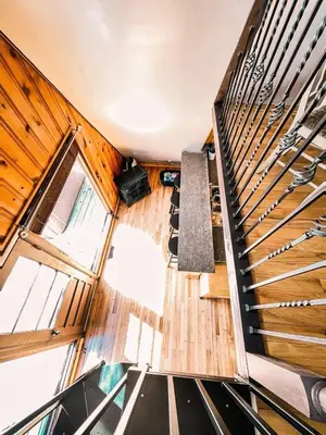 an overhead view of a staircase in a house with wooden floors at Whispering Waters, Hocking Hills, Hot Tub, Pond in Rockbridge
